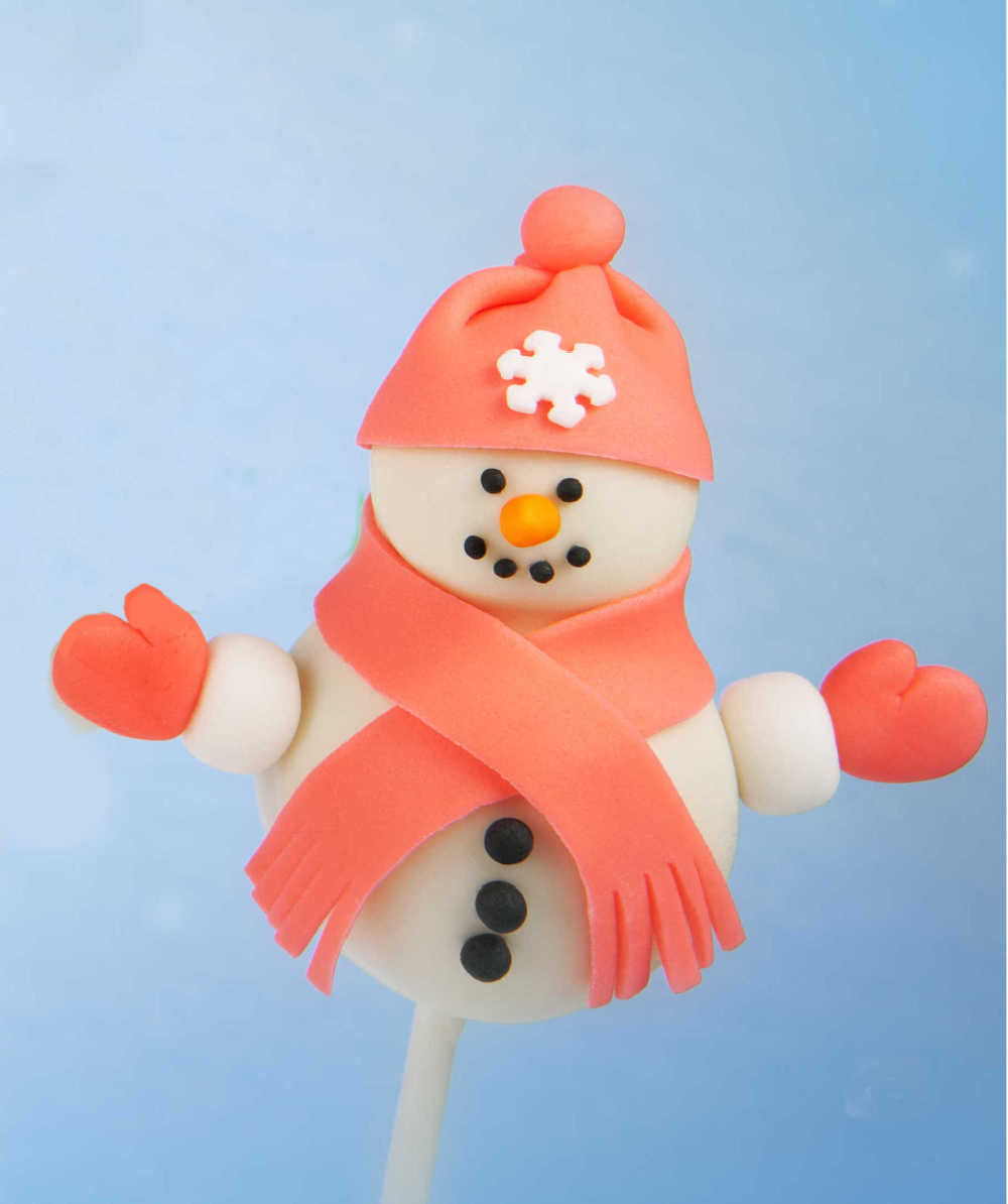 Snowman cake pop with fondant hat, scarf and mittens.