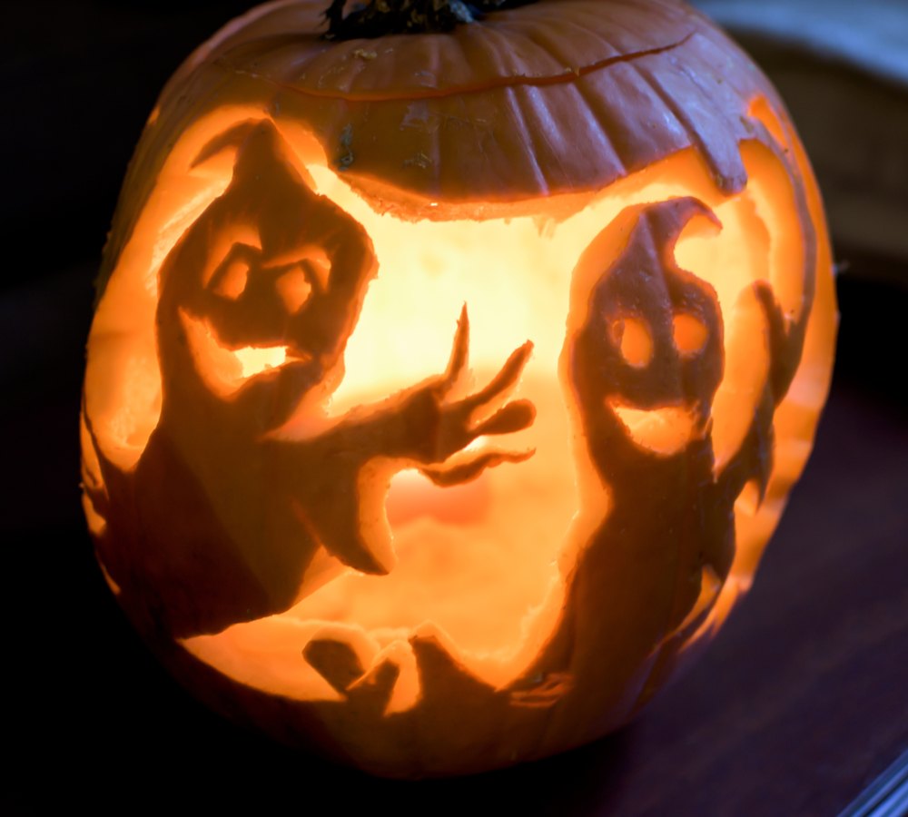 Ghost pumpkin carving. A ghost pumpkin carving with two smiling ghosts on it.