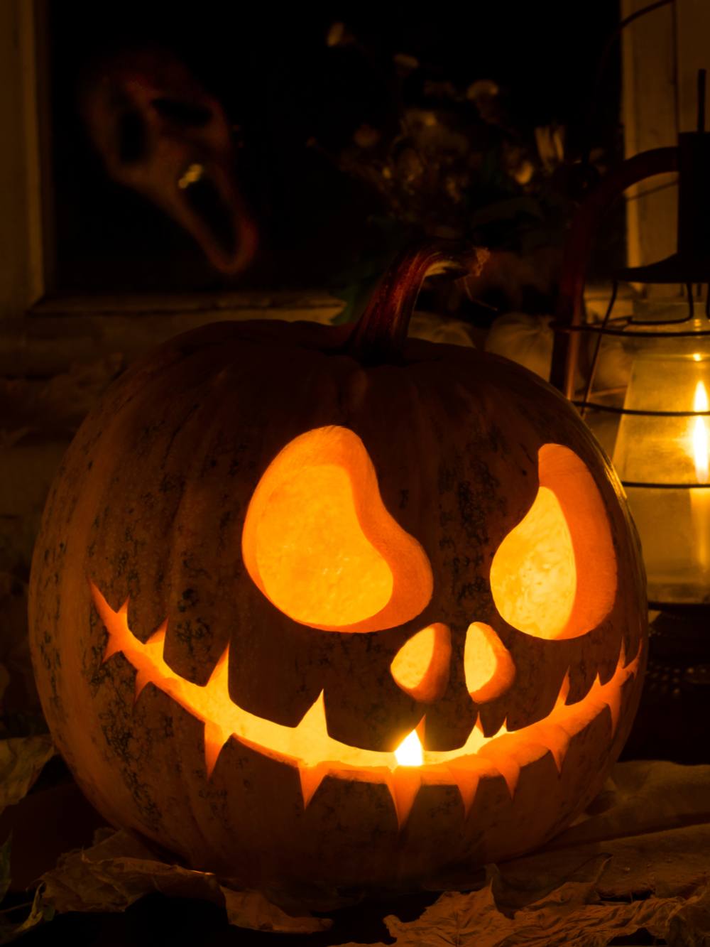 Jack Skellington pumpkin. A Jack Skellington pumpkin carving lit up on a table.