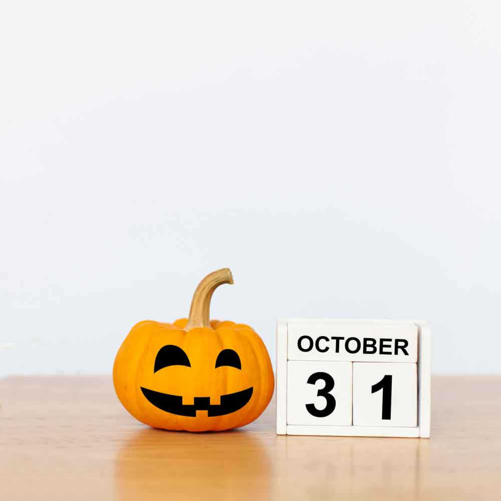 Blocks that say October 31 next to a pumpkin with a black felt smile and eyes.