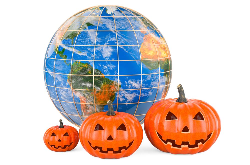 Globe and three jack o lanterns. Three jack o lanterns in front of a globe to answer the question where do pumpkins grow.