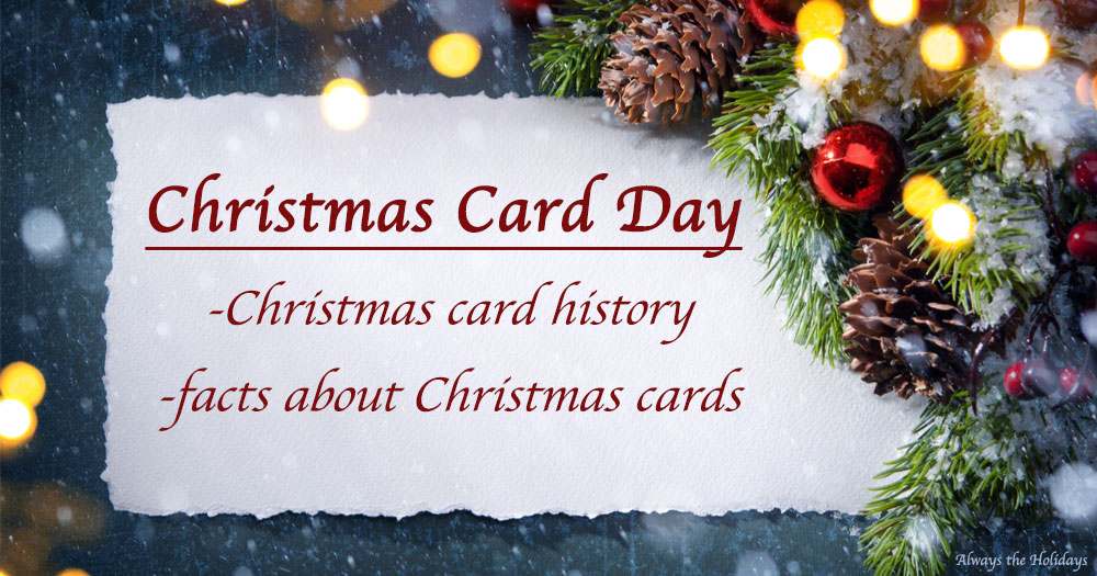 A blue background with a white piece of parchment on it with a text overlay that reads "Christmas Card Day, Christmas card history and facts about Christmas cards" on it, surrounded by pinecones, greenery, ornaments and a bokeh.