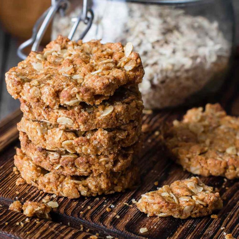 Stack of oatmeal cookies on a wooden board.