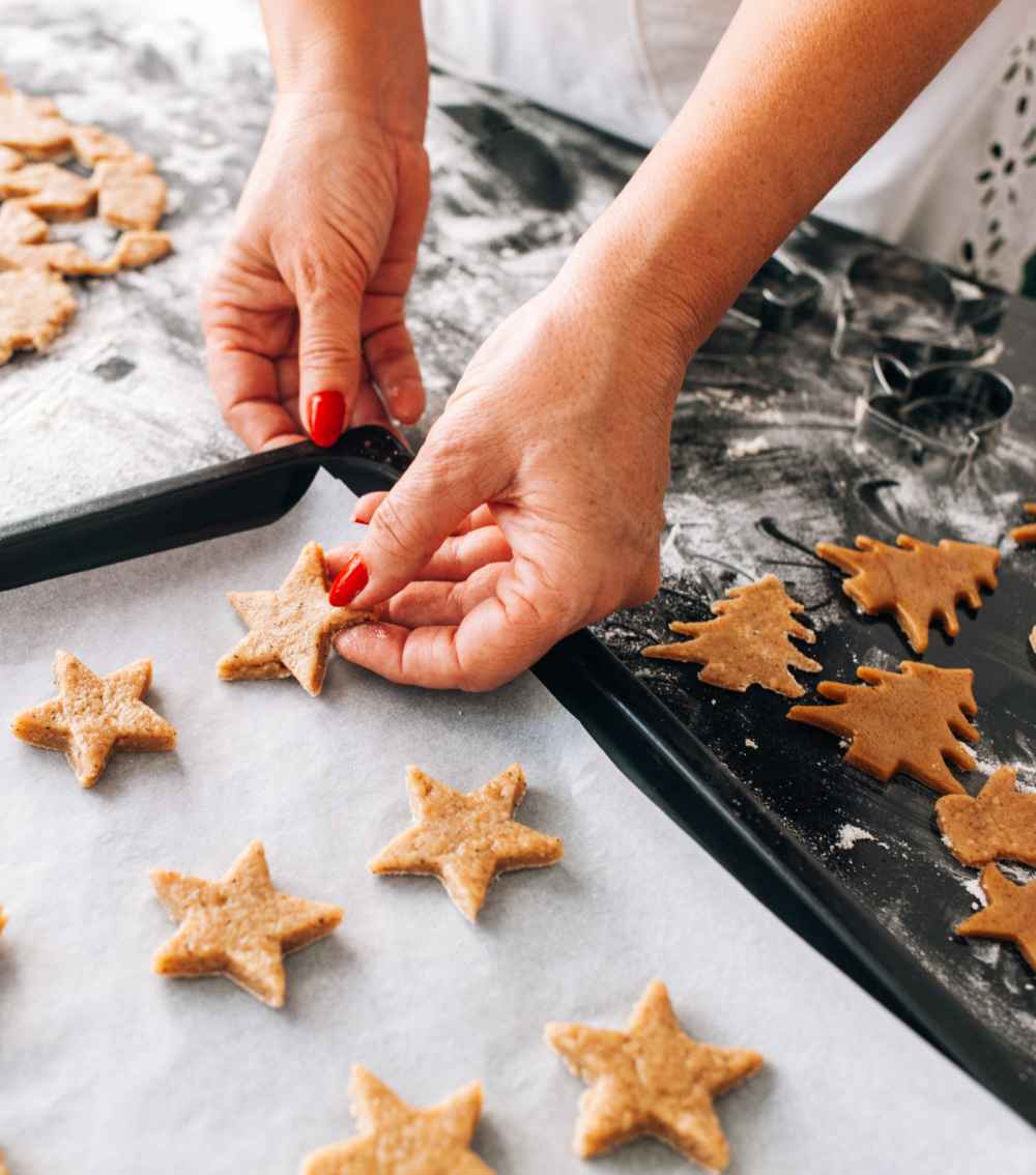 Making Cookies for Bake Cookies Day Woman making star shaped cookies.