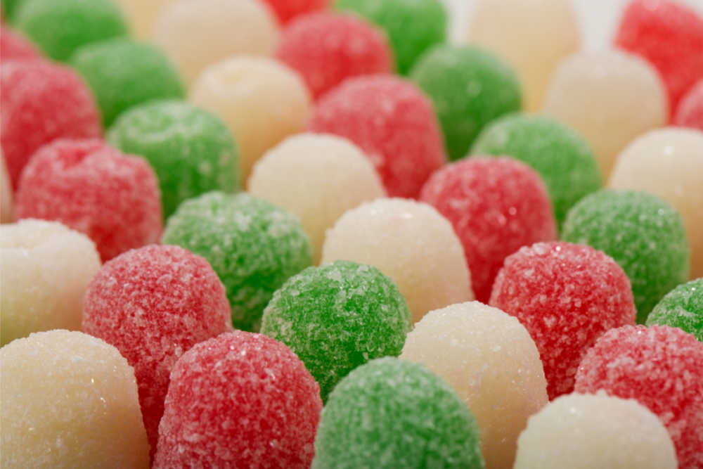 red and green gumdrops Red and green gum drops lined up in rows.
