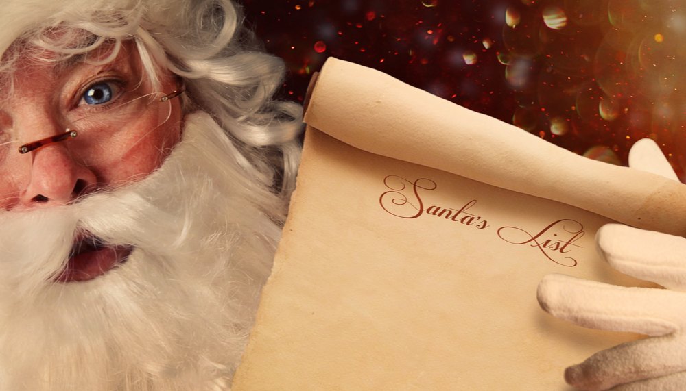 Santa holding his list. A rosy cheeked blue eyed Santa holding up his list for Santa's List Day.