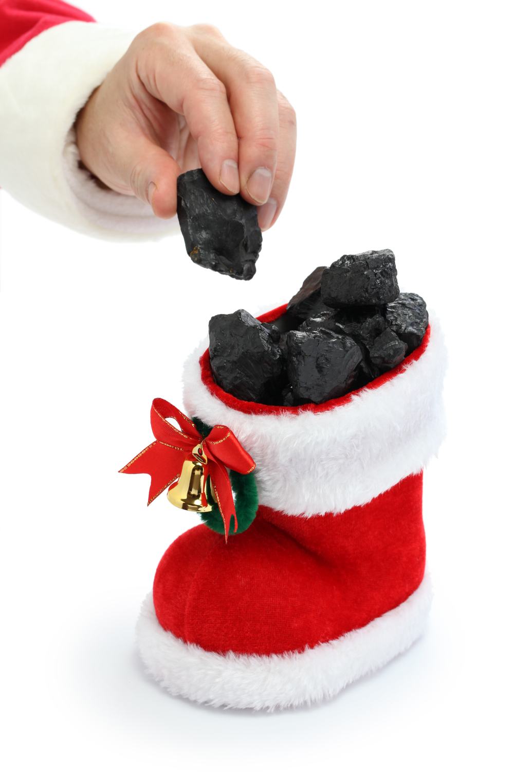 Coal in a stocking. A stocking filled with coal, and a hand reaching to put another piece of coal on top.