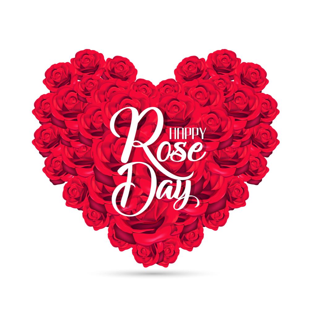 Heart of roses with Happy Rose Day on them A giant heart of red roses with white text in the center that reads "Happy Rose Day".