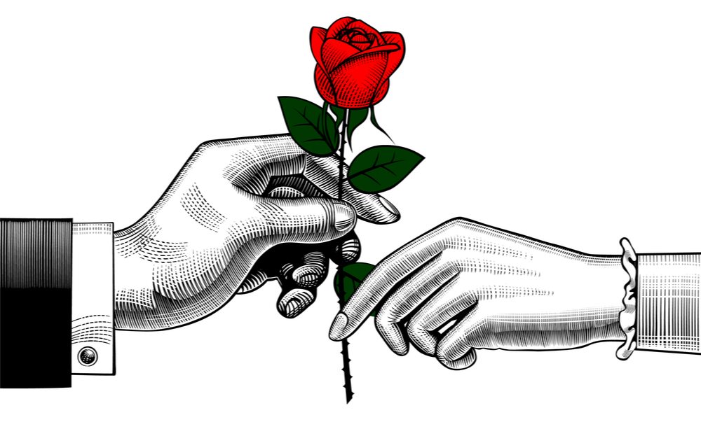 An ink drawing of a man wearing a suit's hand holding a rose and reaching out to a woman's hand with a bracelet on to show why roses are given on Valentine's Day.