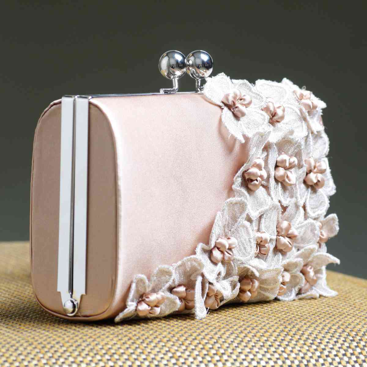Clutch purse A pink clutch purse with pearls and lace flowers attached to it, to resemble on of the Nyx purses passed out as a signature throw during Mardi Gras.