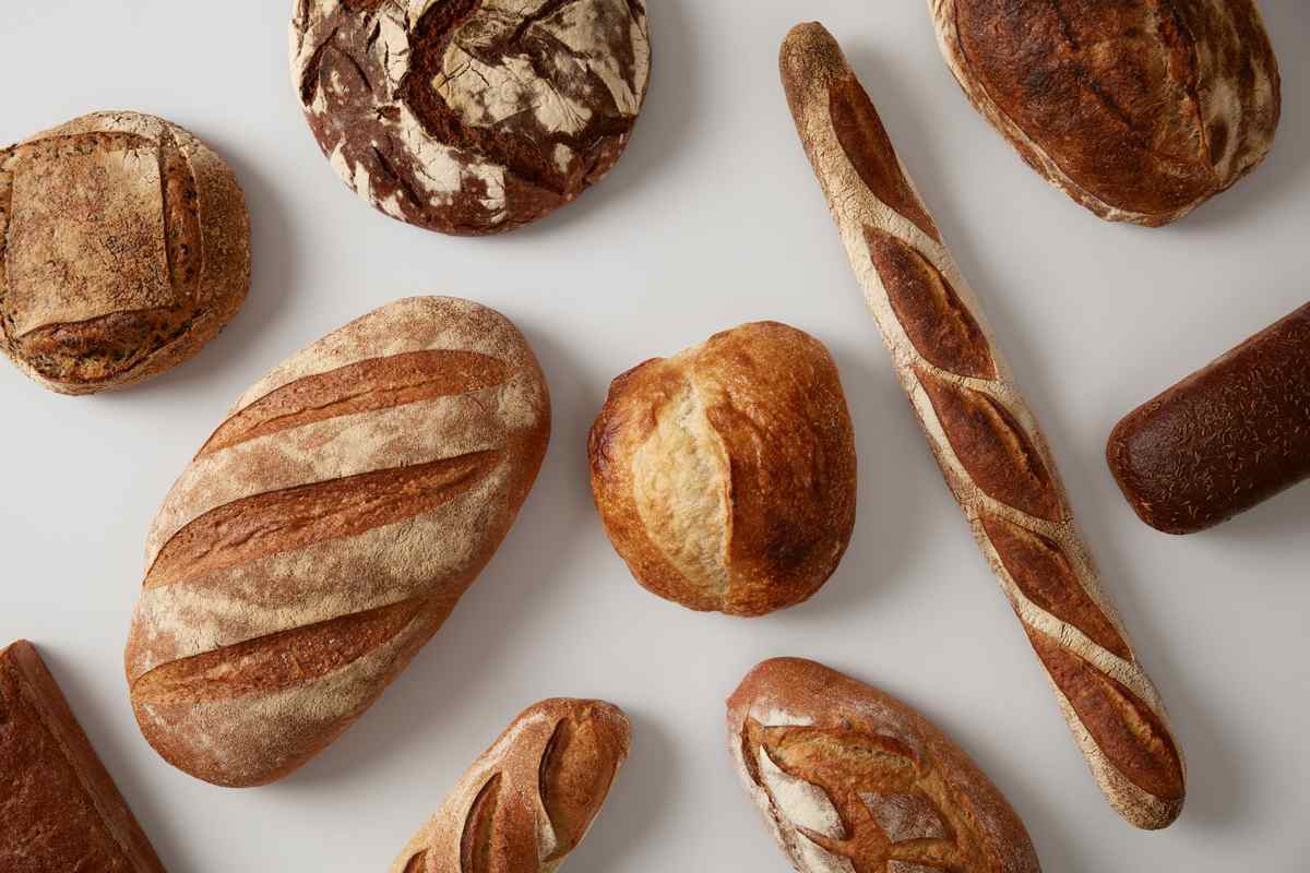 Various artisan breads Various types of bread for National Bread Day, including but not limited to French baguettes, sourdough loaves, and boules.