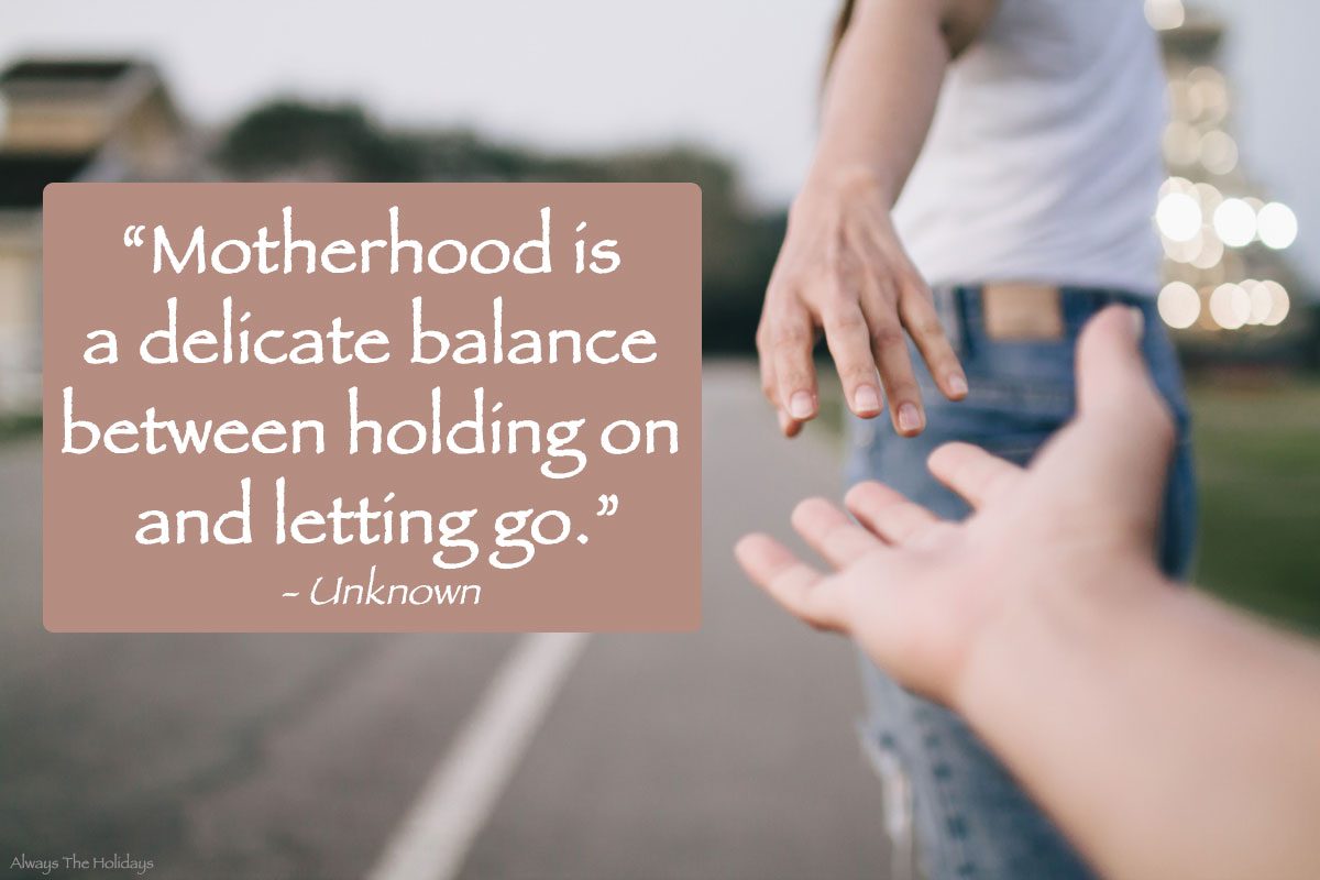 Motherhood quote about balance An inspiring quotes for moms text overlay beside a mother reaching back to her child's hand, with only the hands of the two people visible, not their faces.