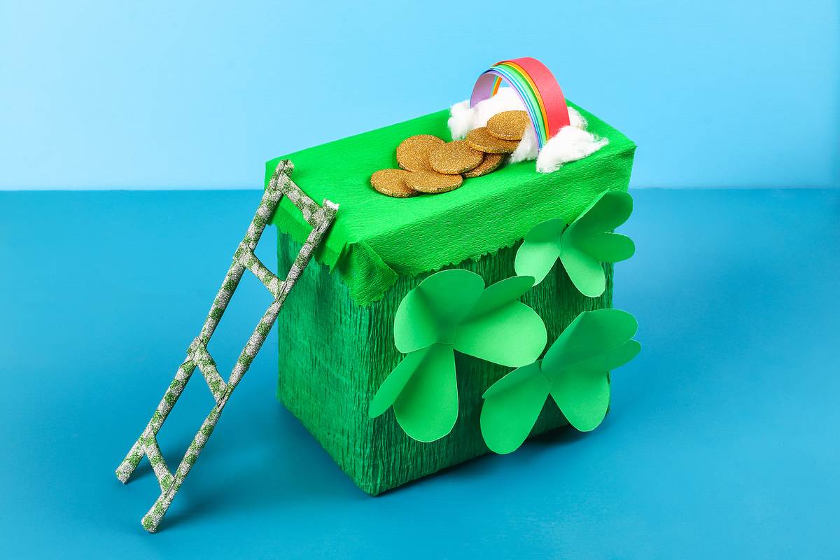 Leprechaun trap A homemade DIY leprechaun trap for National Leprechaun Day decorated with shamrocks and a rainbow with gold under it, with a ladder leading to the gold.