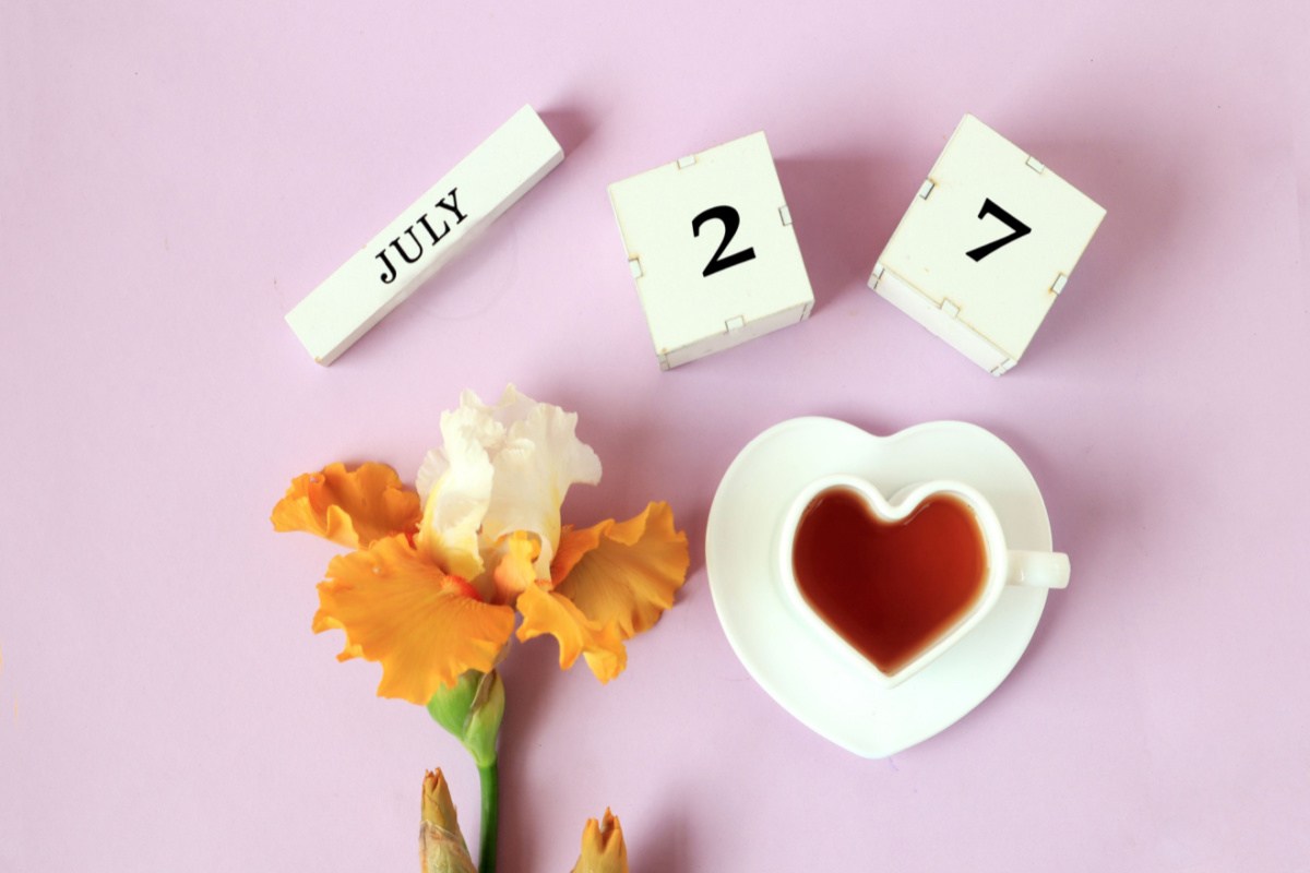 July 27 blocks, flower and coffee Blocks that read July 27, to celebrate the July 27 national days, above a single flower and heart shaped coffee cup on a saucer.