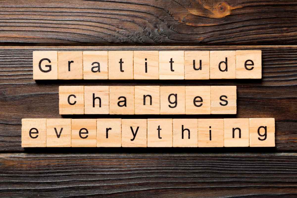 Gratitude quote in scrabble tiles Scrabble tiles spelled out across a dark wooden background to proclaim a gratitude fact which is "gratitude changes everything'.