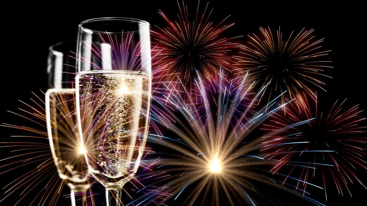 Happy New Year Two champagne glasses and fireworks.