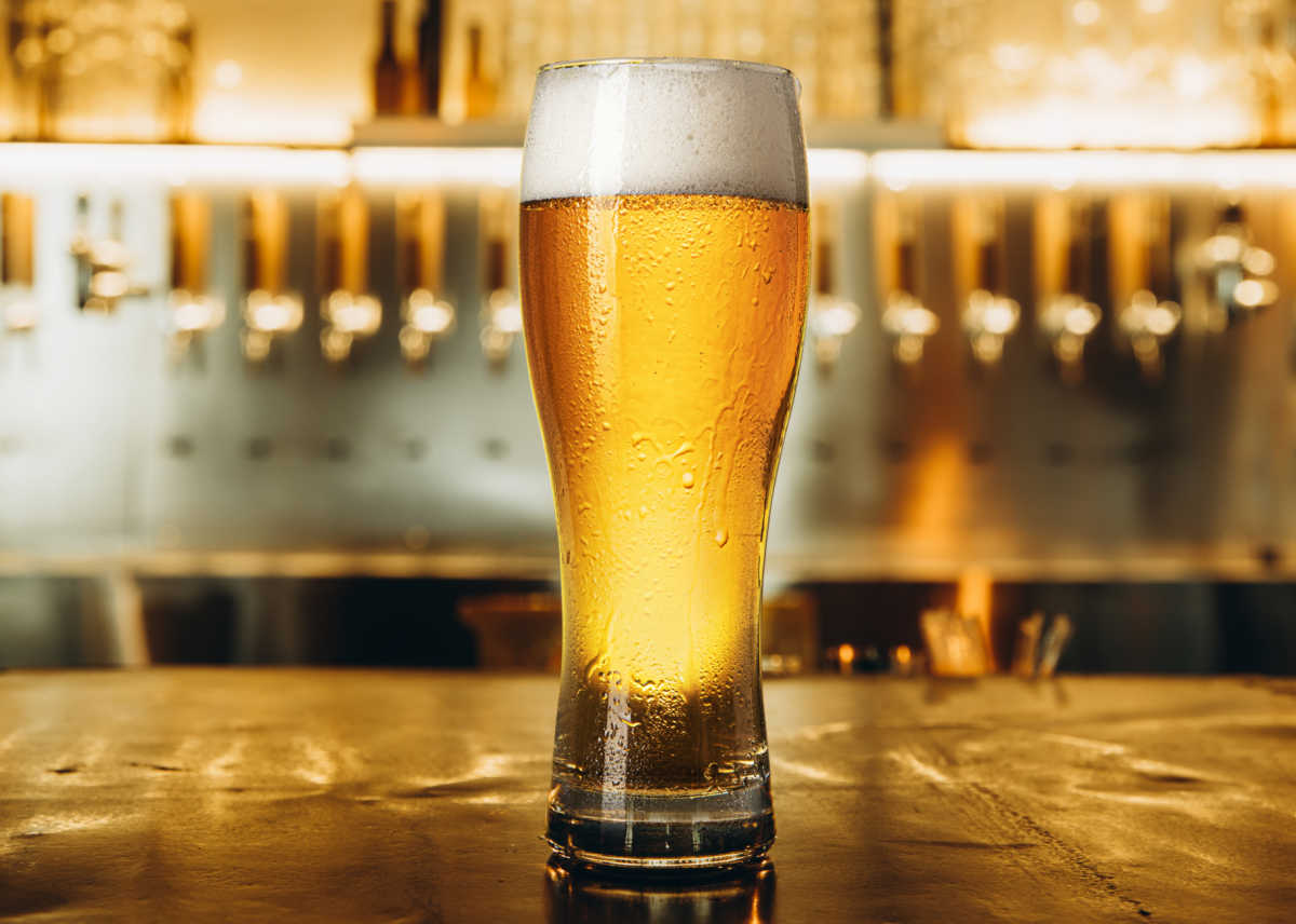 It's national lager day! Lager with foam in a tall glass.