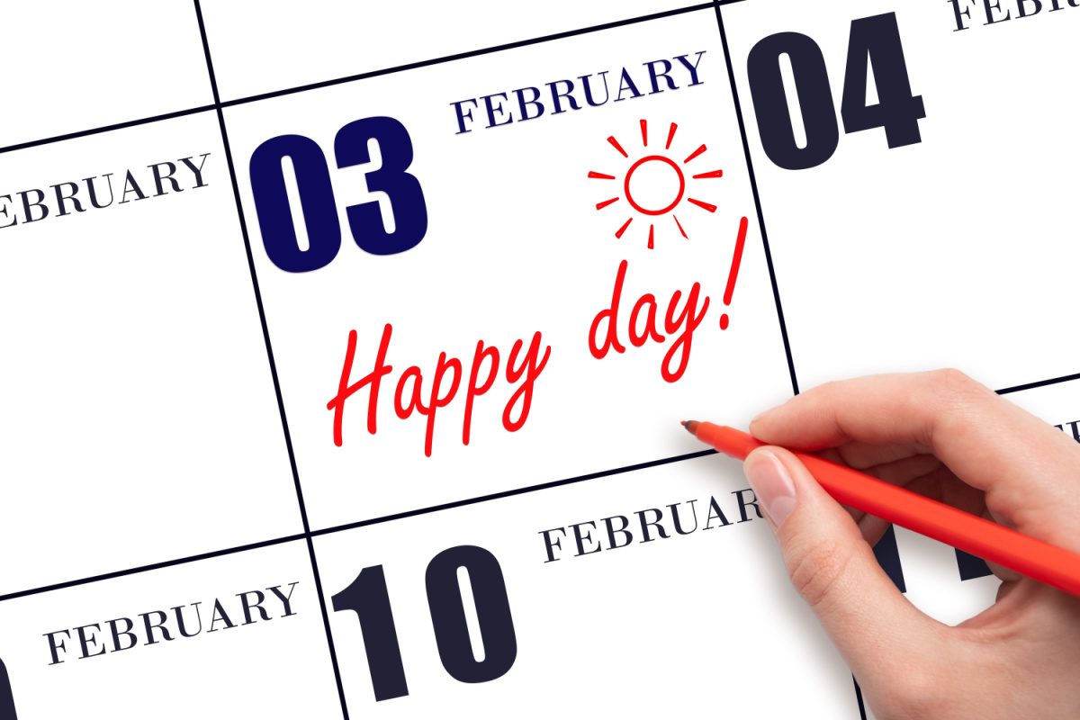 February 3 calendar page February 3 on a calendar with a hand writing "happy day" and drawing a sun on the day to celebrate the February 3 national days.