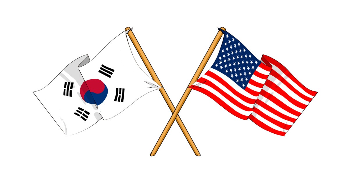 A South Korean flag and a US flag on two poles, crossed, to illustrate the history of Korean immigration to America.