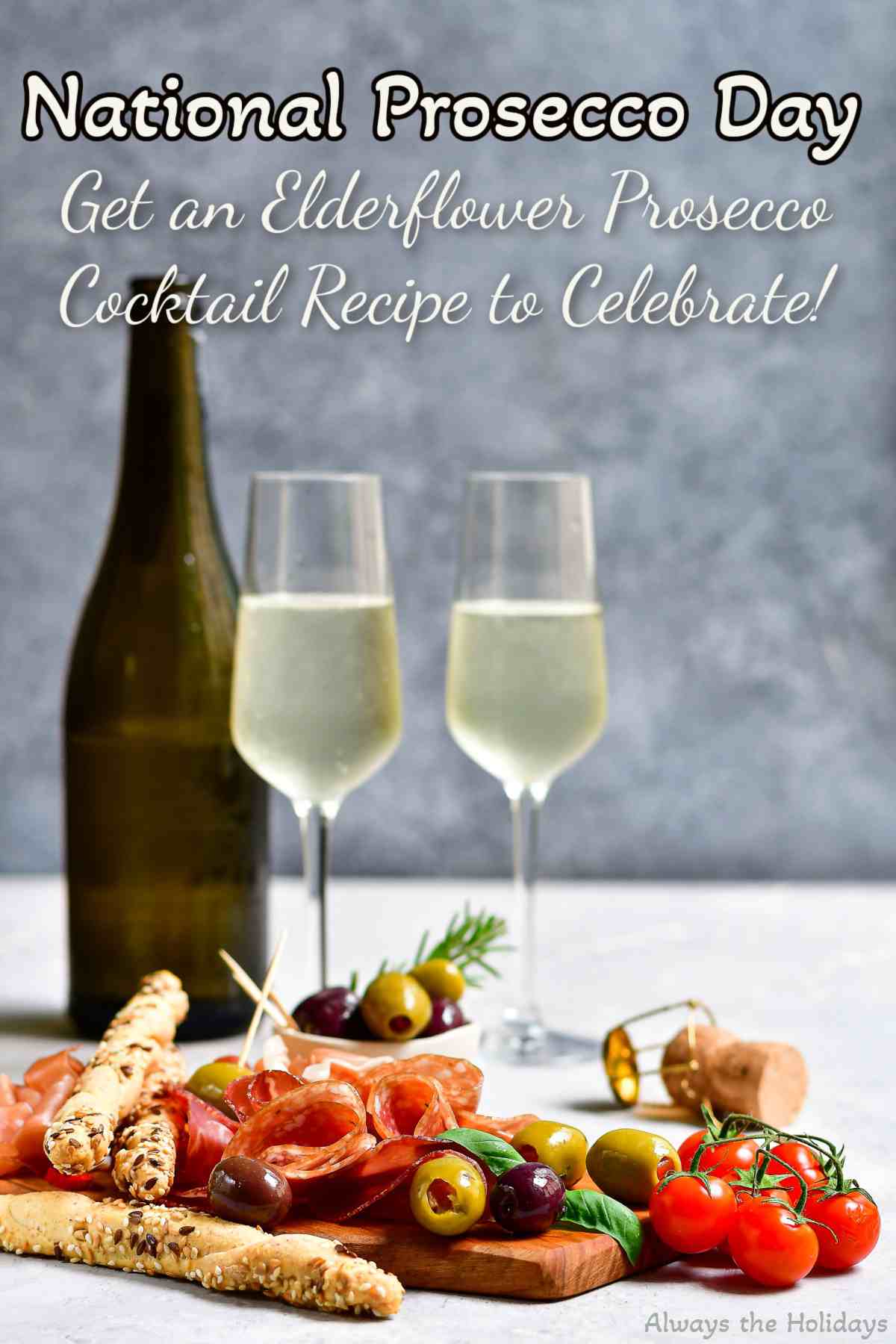 Find out All About National Prosecco Day Text that reads "National Prosecco Day - get an elderflower Prosecco cocktail recipe to celebrate" above a bottle of Prosecco with two glasses beside a charcuterie board.