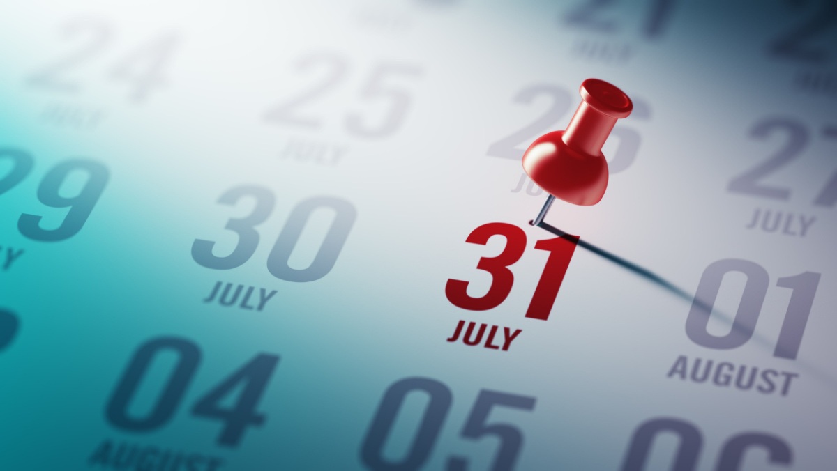 A calendar with a red pushpin on July 31.