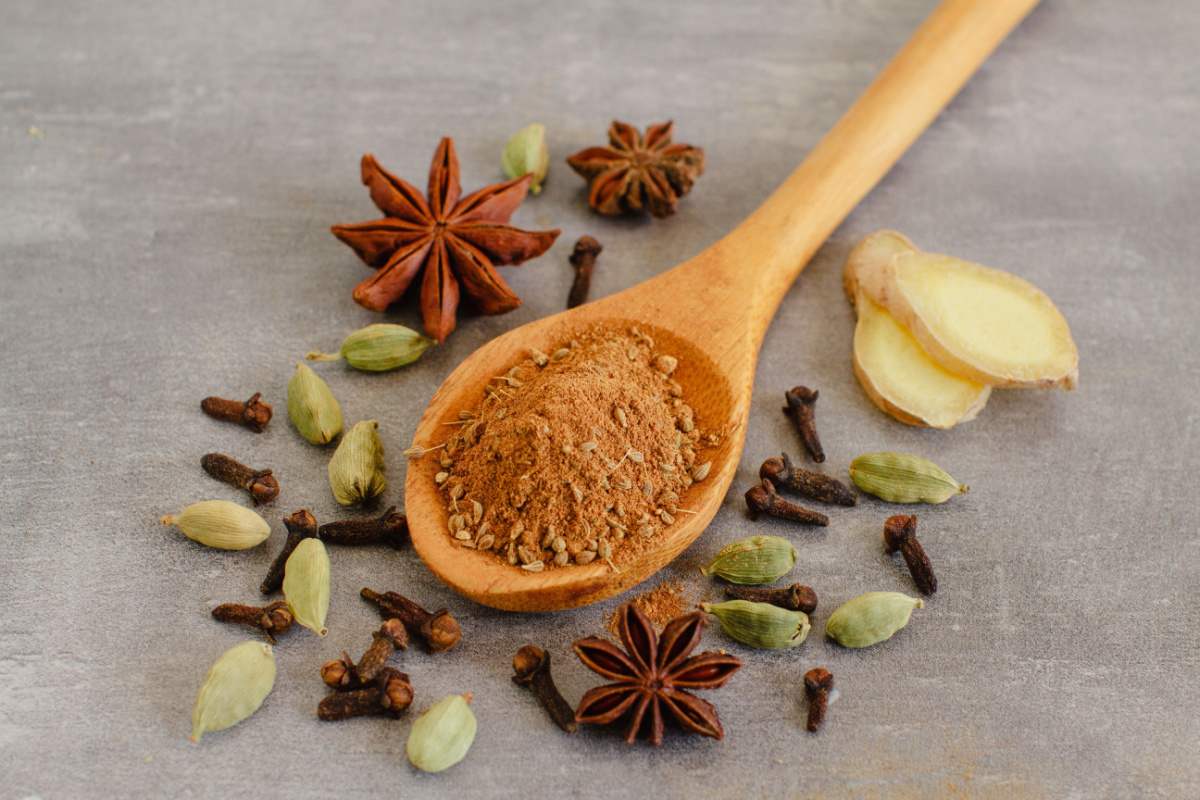 Spices for spiced rum A collection of different spices used for infusing spiced rum including cloves, cardamom, star anise, ginger and cinnamon which is being held in a spoon.