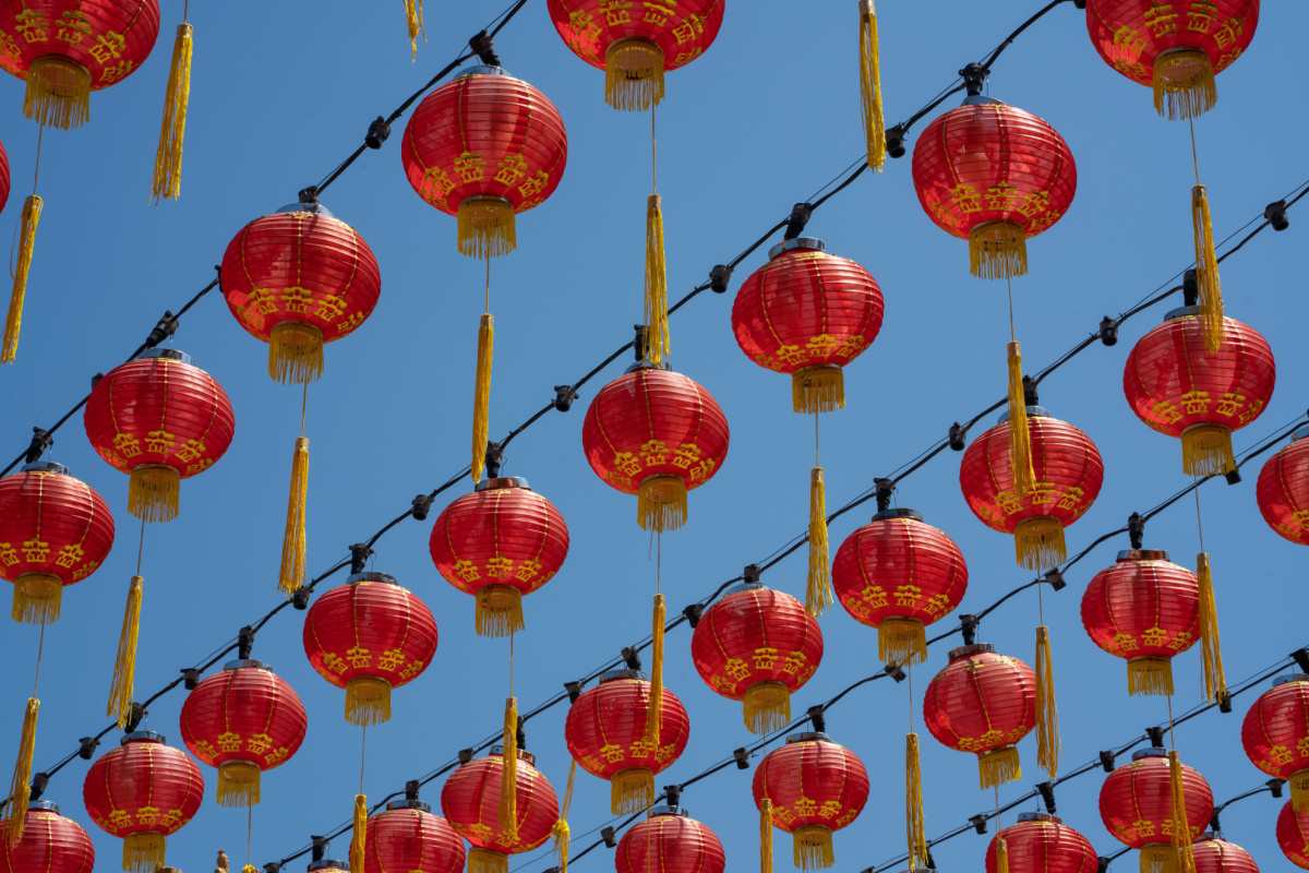 Red lanterns for Chinese New Year A blue sky filled with six rows of Chinese New Year red lanterns with golden tassels hanging on wires.
