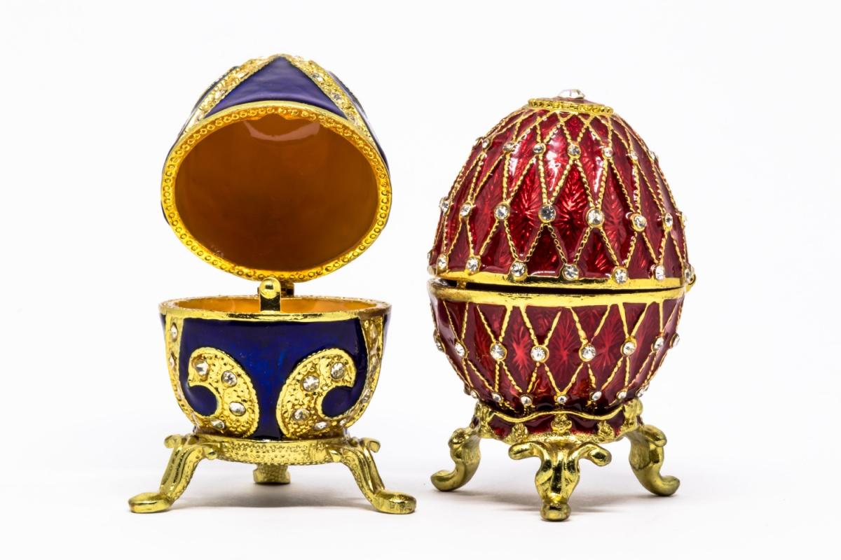 Faberge eggs Two Faberge eggs, the one on the left is blue and gold, and open, and the one on the right is gold and red and closed.
