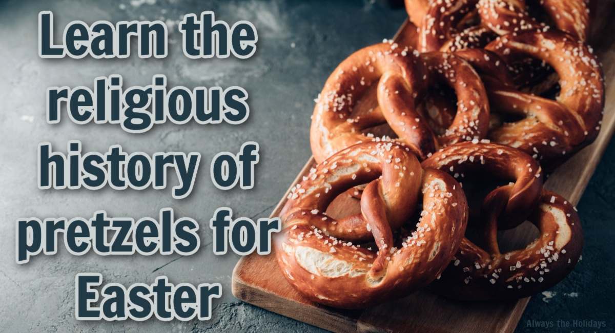Pretzels on a cutting board and a text overlay A wooden cutting board filled with homemade soft pretzels against a slate grey background with dark blue about the religious history of the pretzel for Easter.