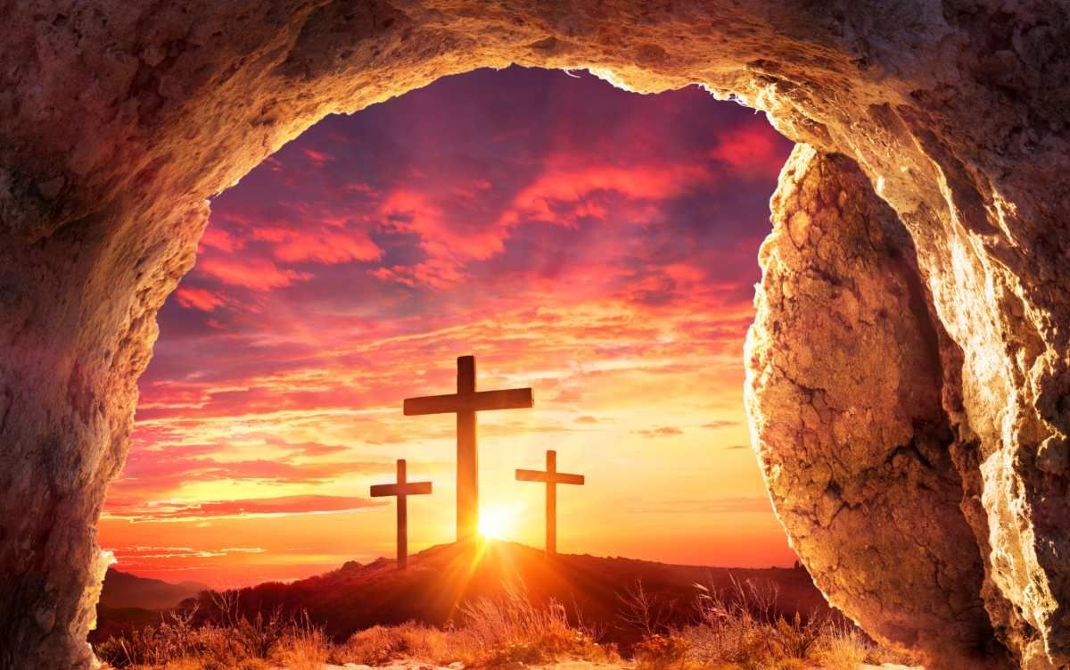 Jesus's tomb and crosses An image of Jesus's empty tomb facing a sunset with three crosses on a hill, to symbolize the religious meaning of Easter eggs, which are a symbol of Easter.