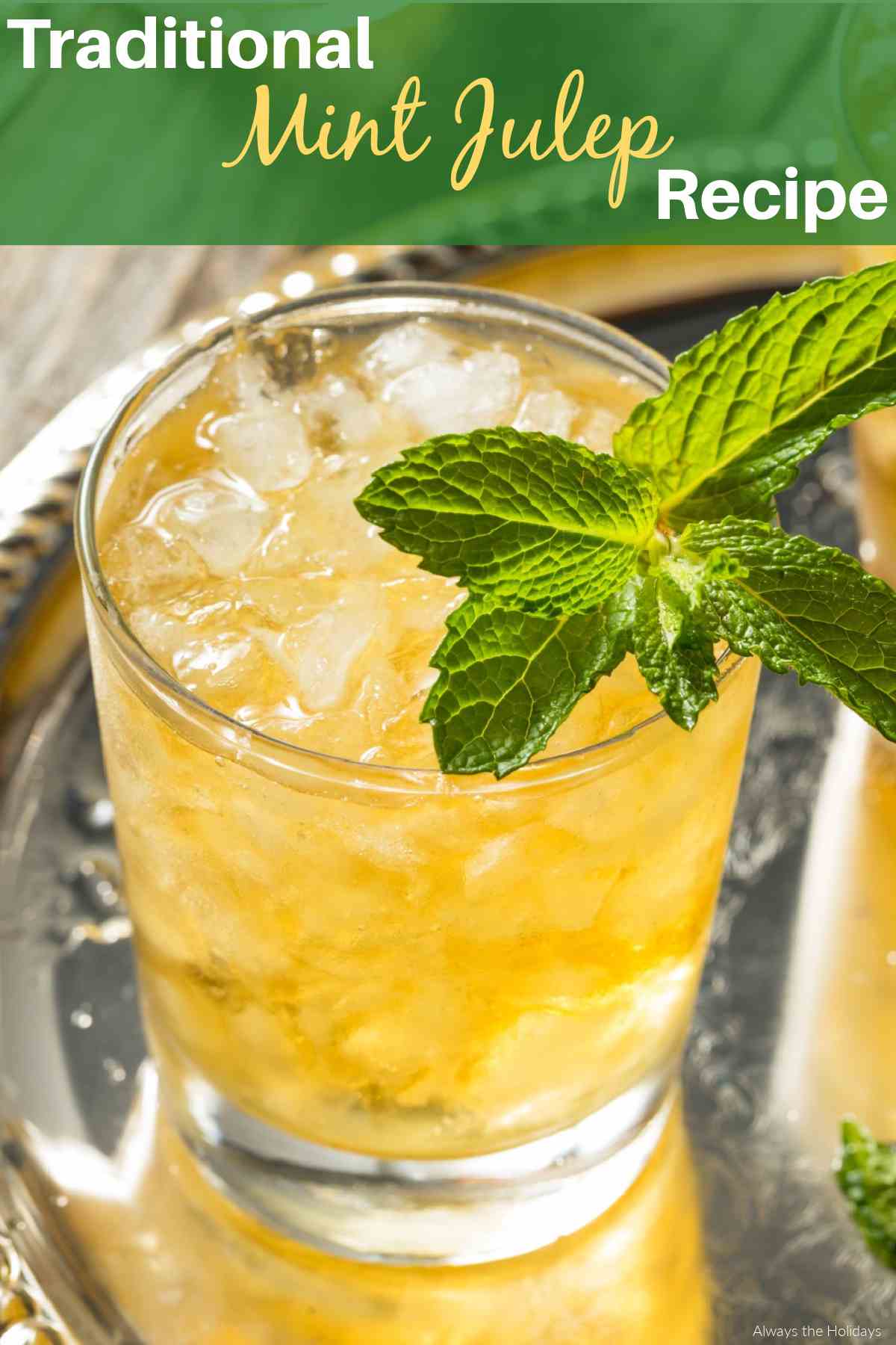 Celebrate National Mint Julep Day with a Mint Julep Recipe! A rocks glass filled with a mint julep in the background, and dark green rectangle at the top of the image with white and yellow text that reads Traditional Mint Julep Recipe across it.