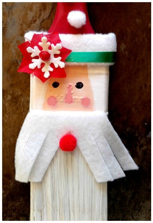Paint brush decorated in an image of Santa Claus.