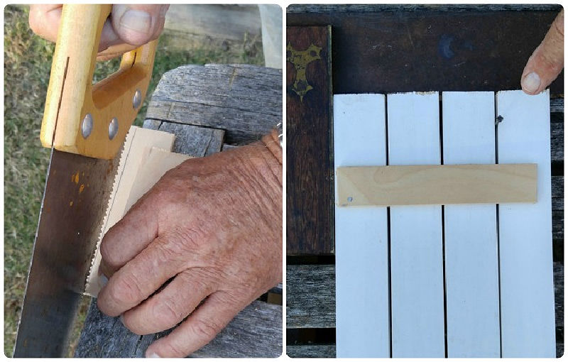 Mans hand with a saw, cutting wood, and pieces of wood with a brace on the back and a nail to space the boards.