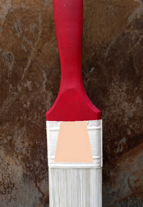 Paint brush painted red and white with a peach area for face painting.