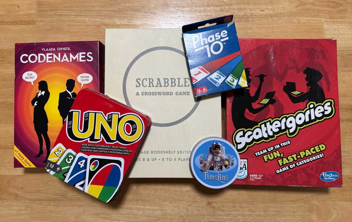 Board games Six board games on a wooden table, including Code Names, Uno, Scrabble, Phase 10, Timeline and Scattergories.