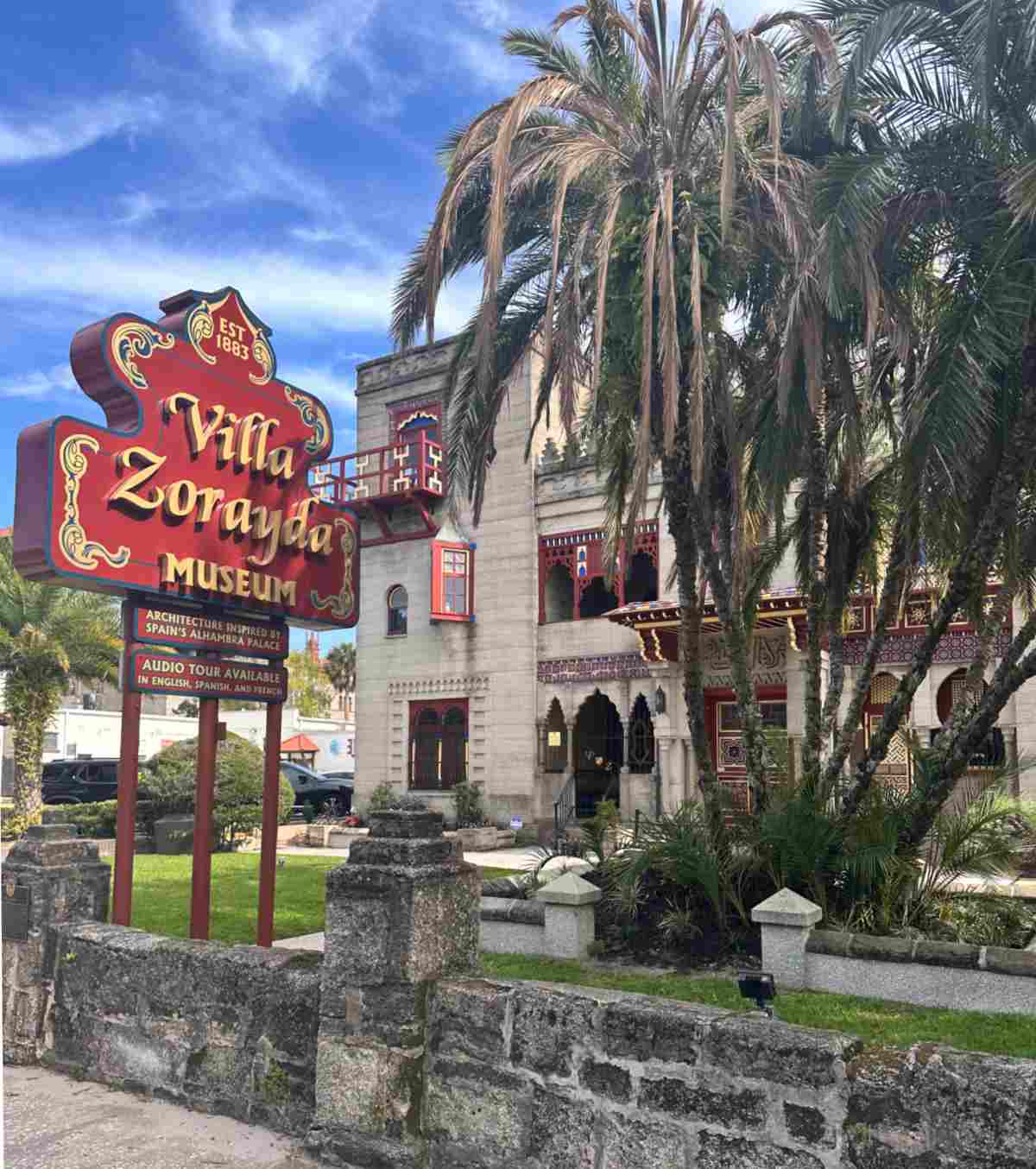Villa Zorayda Museum An outside video of St. Augustine Florida's Villa Zorayda Museum and its sign from the road, and the building is partially blocked by a clump of palm trees.